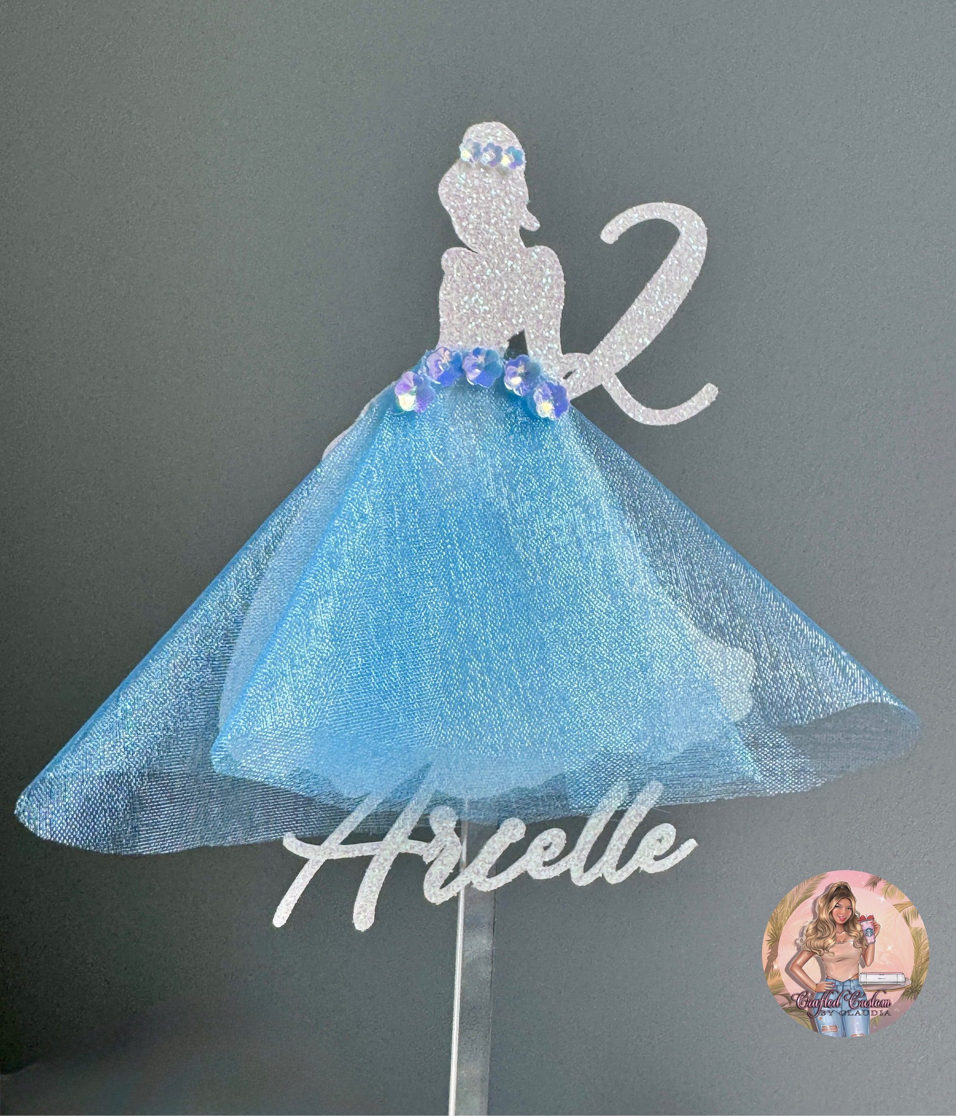 Decorative cinderella cake topper with blue skirt and glitter flower embellishments 