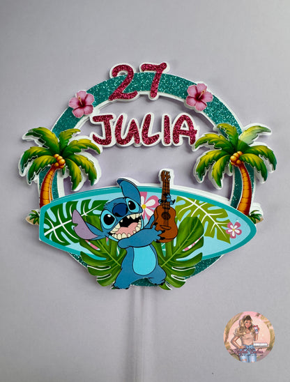 Decorative cake topper with cartoon stitch character, palm trees, and pink text background