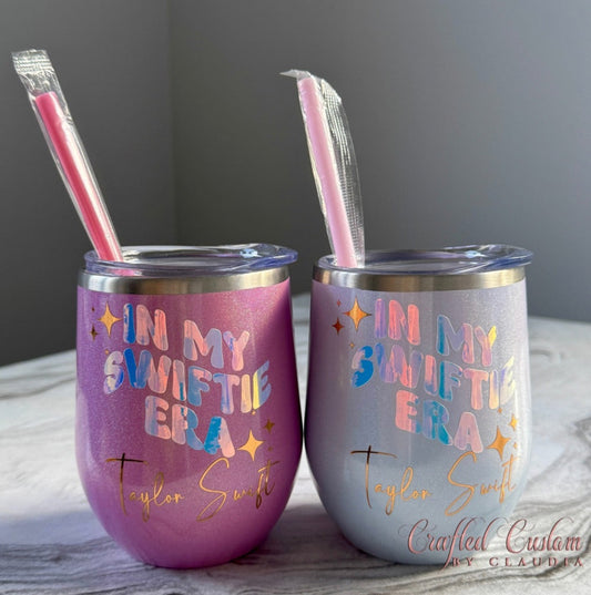 Two tumblers with 'In My Swiftie Era' text and straws on a gray background